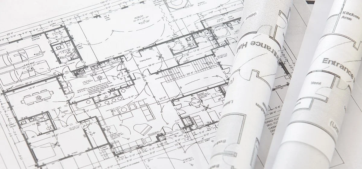 Architectural blueprints of a commercial building layout with detailed floor plans and room dimensions.