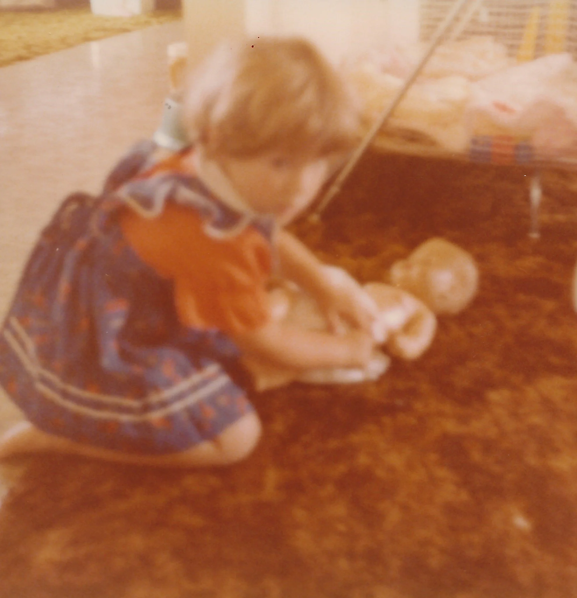 A blurry image showing a small part of a wooden surface with some objects that are not clearly identifiable.