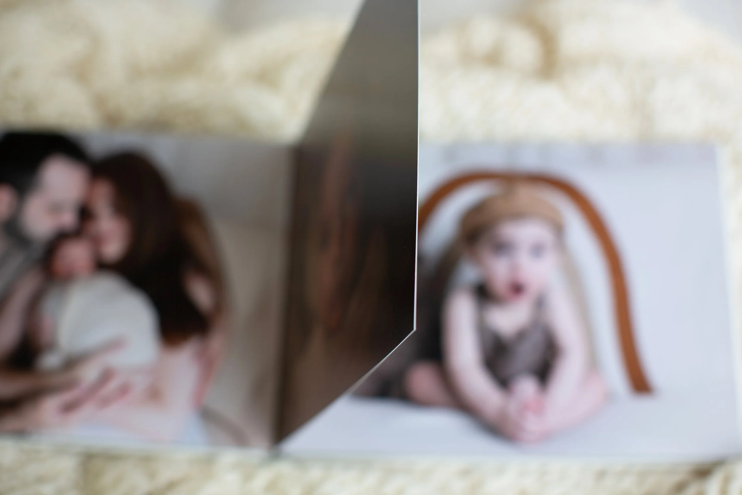 Blurred photo of two women, one with dark hair and the other with reddish hair, talking or interacting in an indoor space.