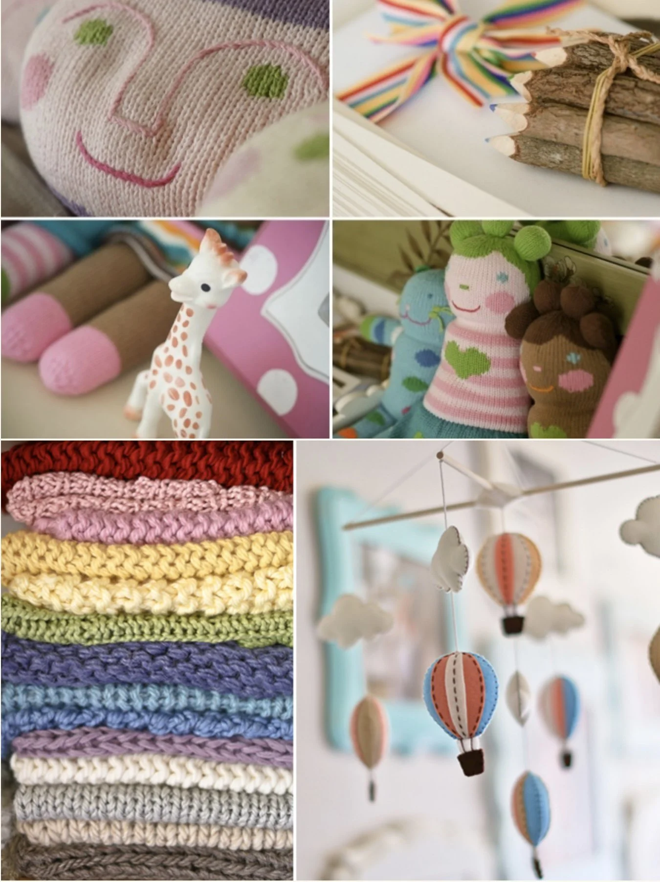 Collection of colorful baby toys and accessories including embroidered socks, wooden sticks tied with ribbon, plush giraffe, cartoon-style socks, hand-crocheted blankets, and hanging mobile with paper hot air balloons and clouds.