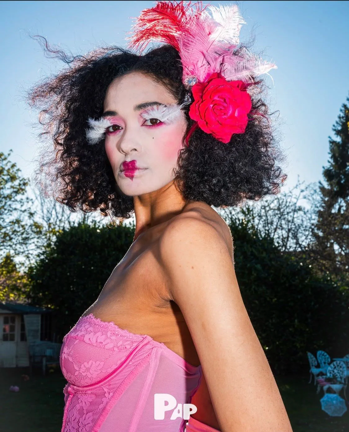 Beauty and fashion styling: Detailed view of vibrant pink lace and feathered eye.
.