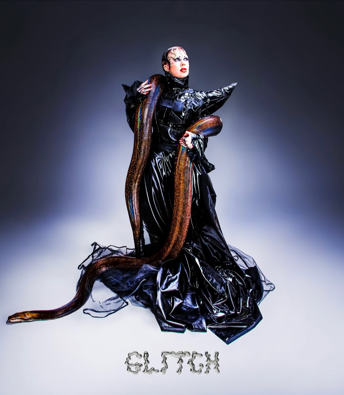Editorial styling for GLITCH-MAGAZINE: Conceptual fashion illustrating structured black textures and snake-handling.