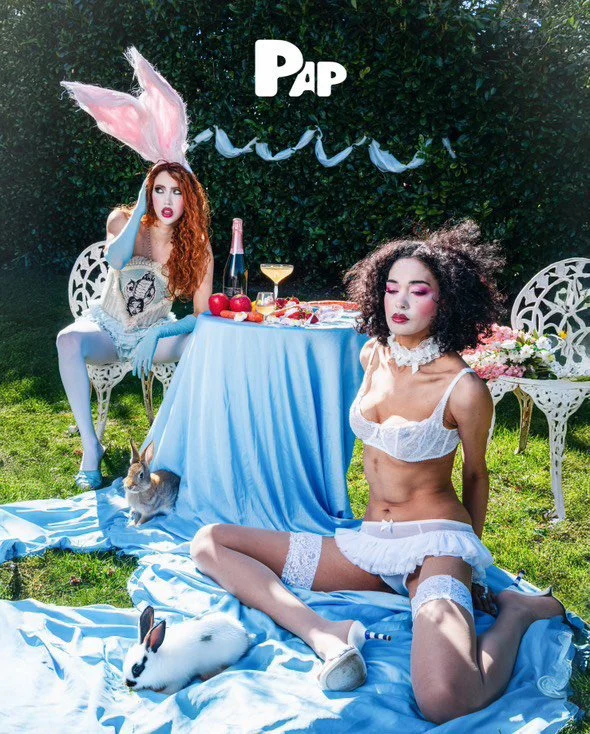 Whimsical editorial styling: Models in vintage lingerie and bunny accessories for a conceptual garden fashion story.