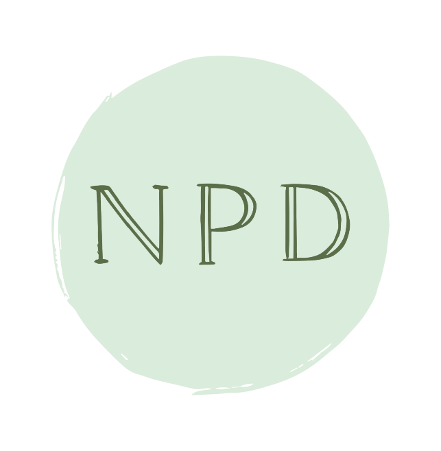 A light green circular badge with the letters 'NPD' written in the center in a stylized font.