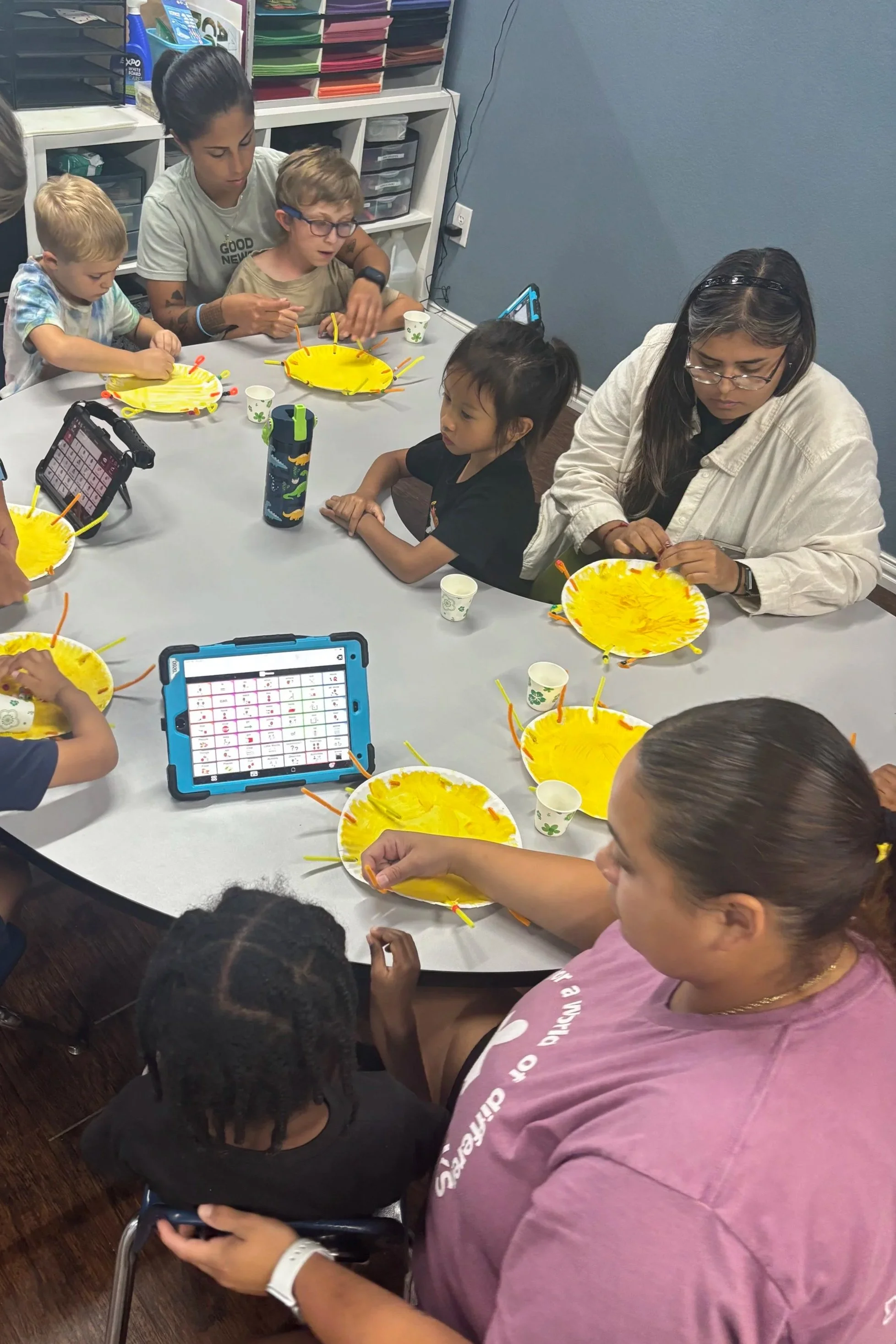 ABA therapy services with children and therapist engaging in group art activities for early intervention, school-age, and life skills support