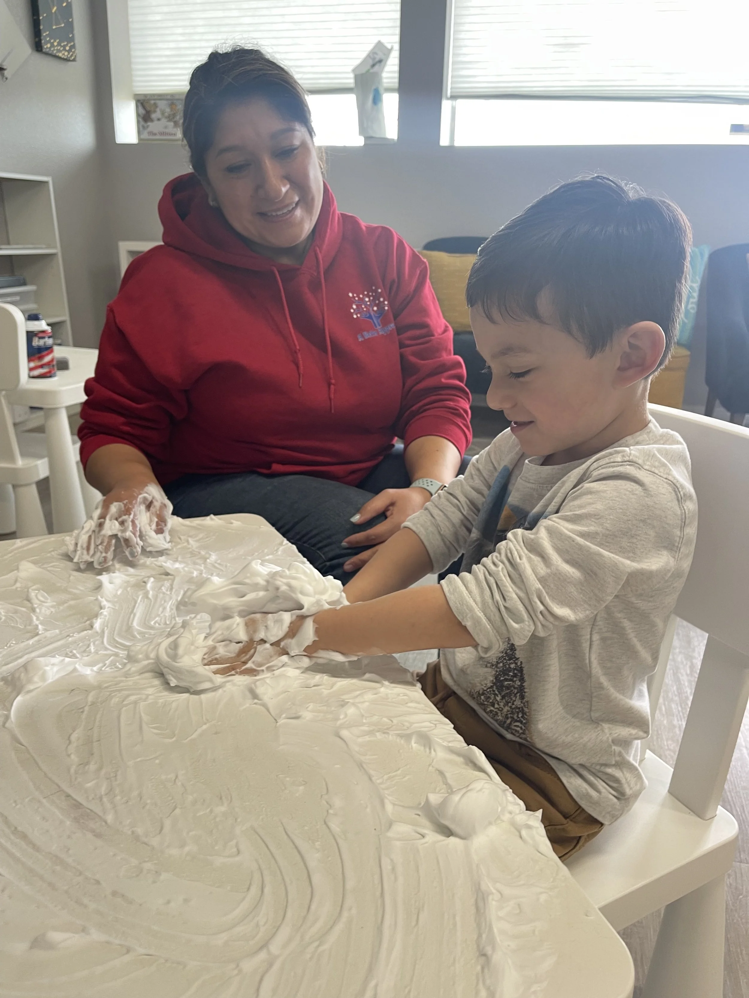 Registered Behavior Technician and child engaging in a sensory play activity during an ABA therapy session