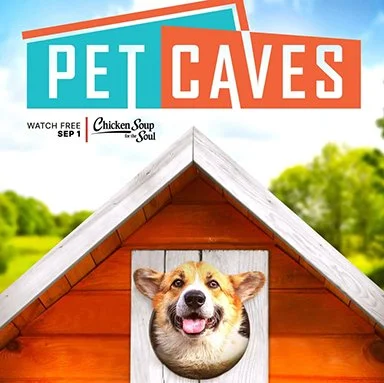 A doghouse with a corgi dog's face peeking out of the door, set against a grassy outdoor background under a partly cloudy sky. The sign above reads 'Pet Caves' and mentions 'Watch free September 1' with 'Chicken Soup for the Soul' branding.