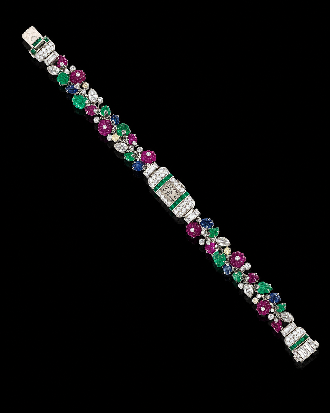 Bracelet en or blanc avec des pierres précieuses colorées en forme de fleurs et de feuilles, intégrant une montre fine, sur fond noir.