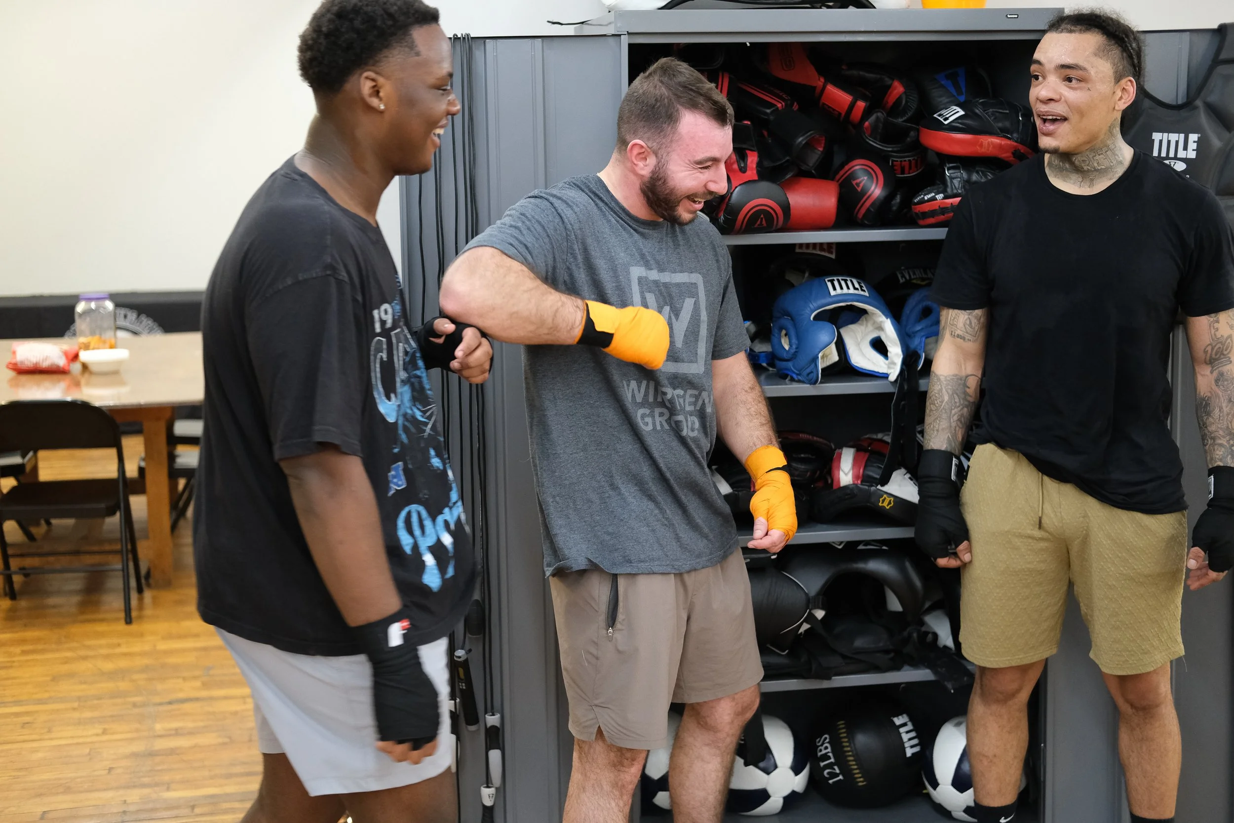  Jamere Smith (from left), Francis Cerio and Albert Appleton joke around after their workout. Photo by Jirah Johnson.  