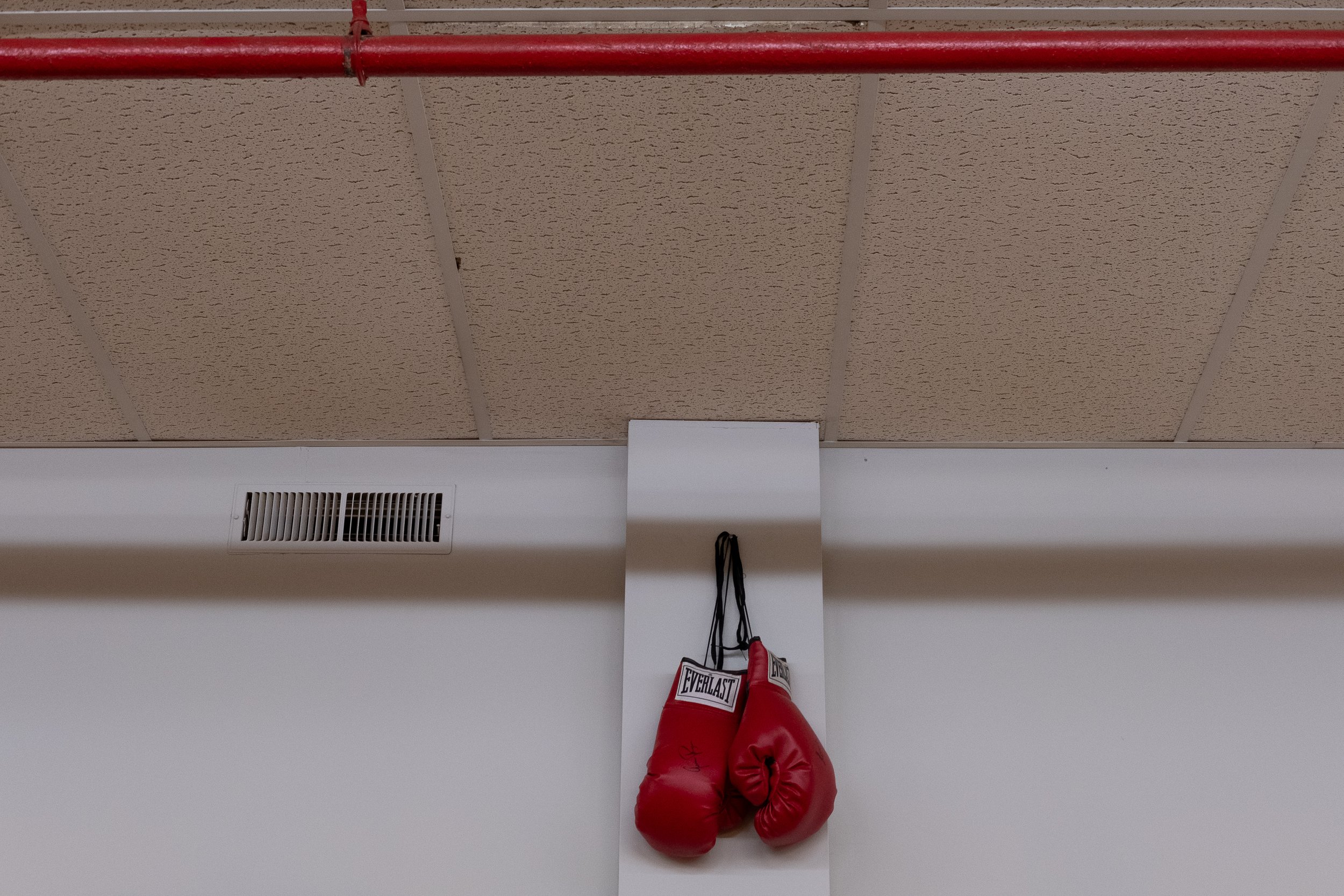  Boxing gloves hang above the gym. Photo by Rabia Mustafa.  