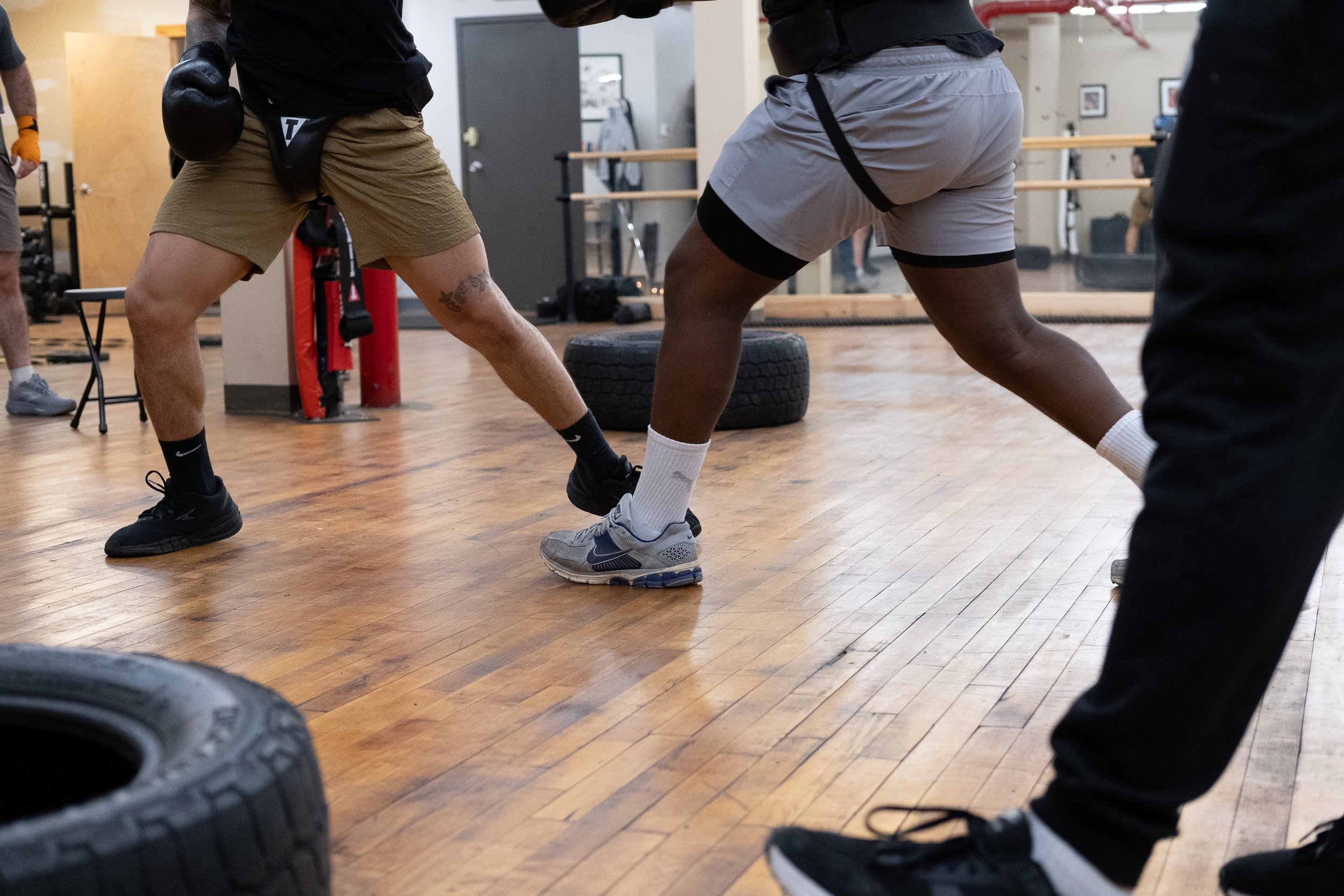 The legs and footwork of two students are seen during a sparring drill. Photo by Rabia Mustafa. 