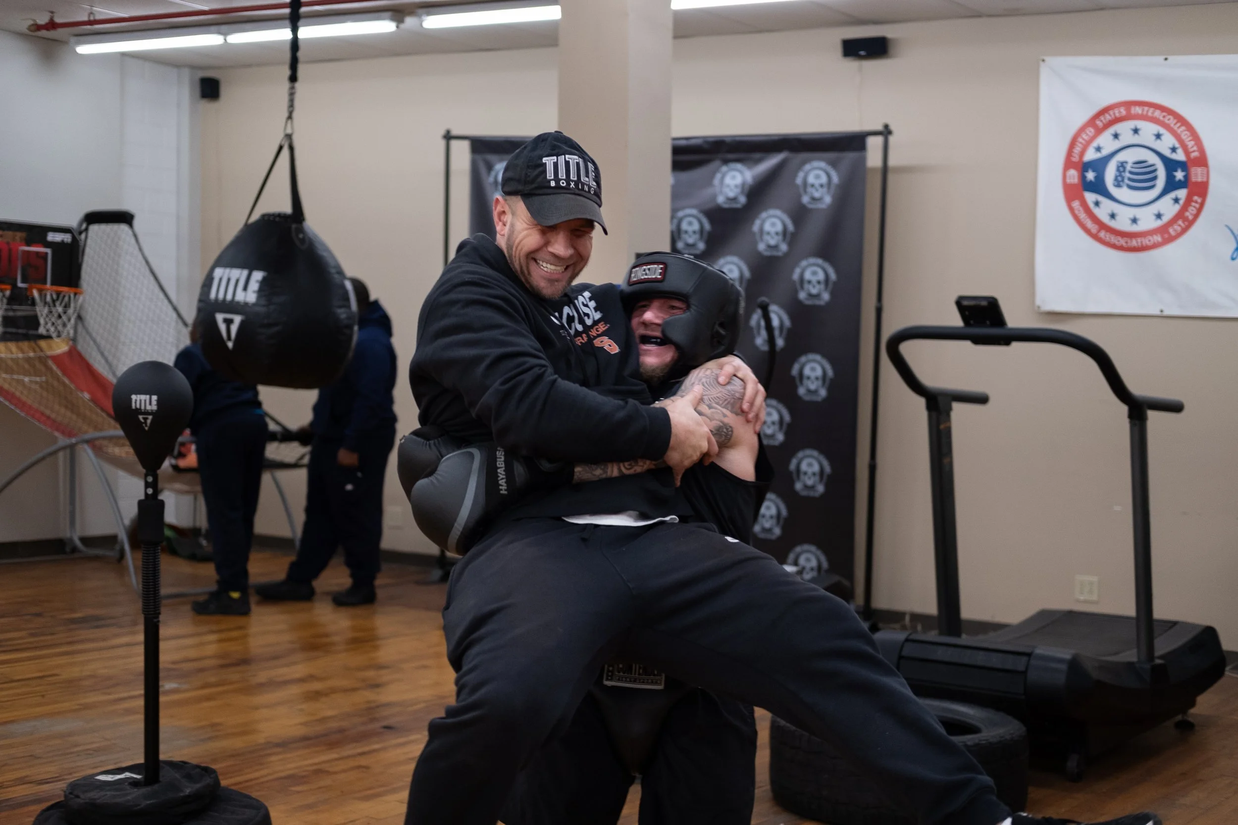  Coach Joe Stray (left) laughs as he is picked up by Ryon Fogarty. Photo by Rabia Mustafa.  