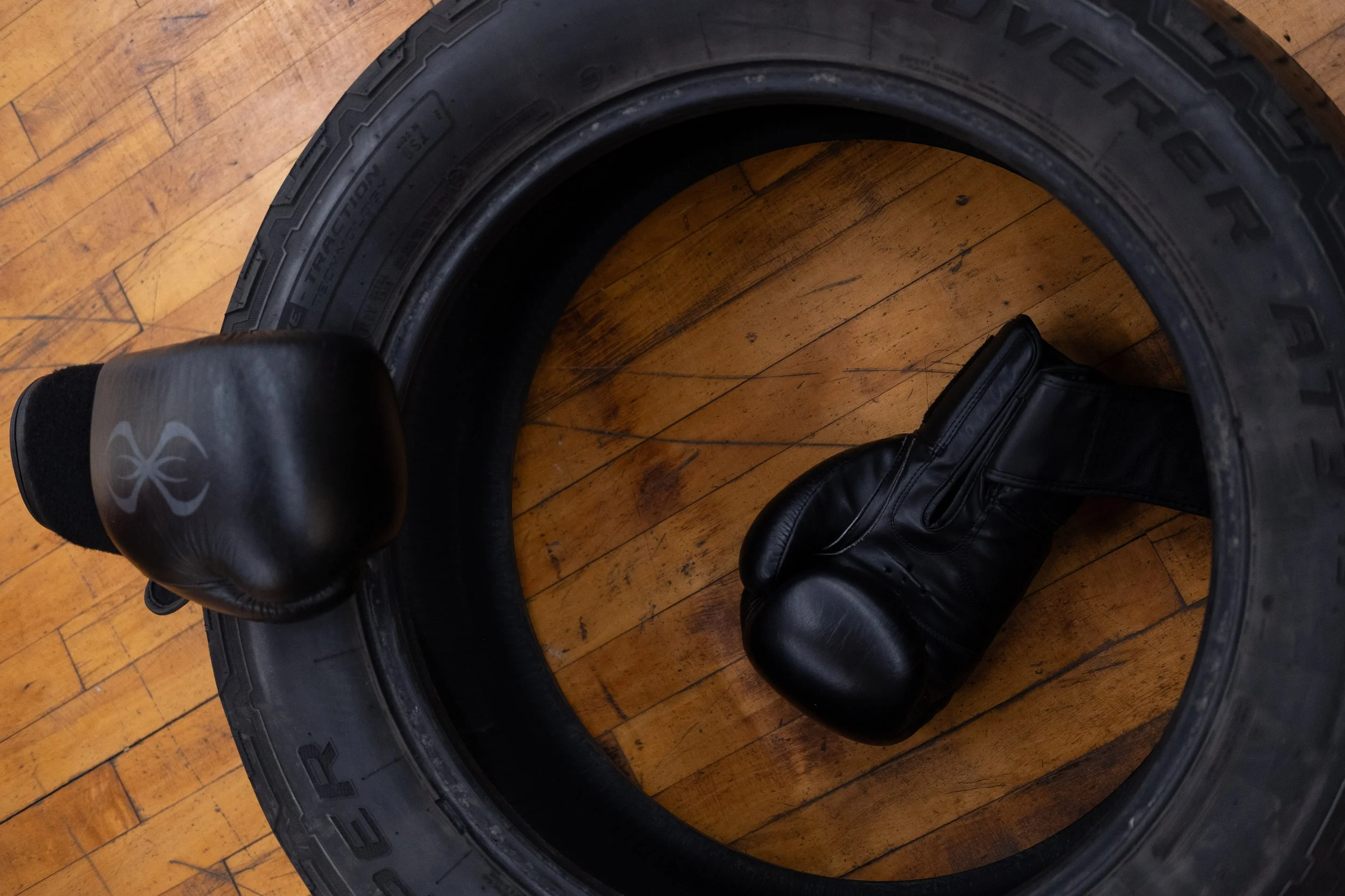  Discarded boxing gloves litter the floor as boxers take breaks. Photo by Rabia Mustafa. 