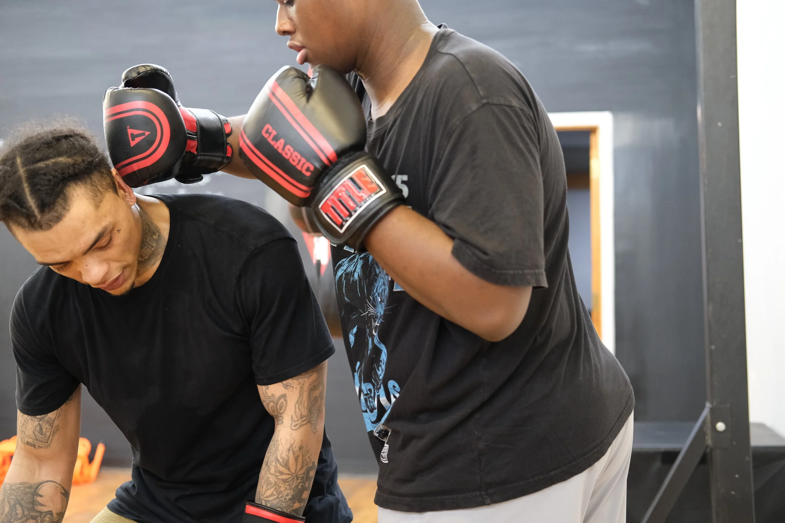  Albert Appleton (left) reacts to a slow punch by Jamere Smith as the two practice their movements. Photo by Jirah Johnson.  