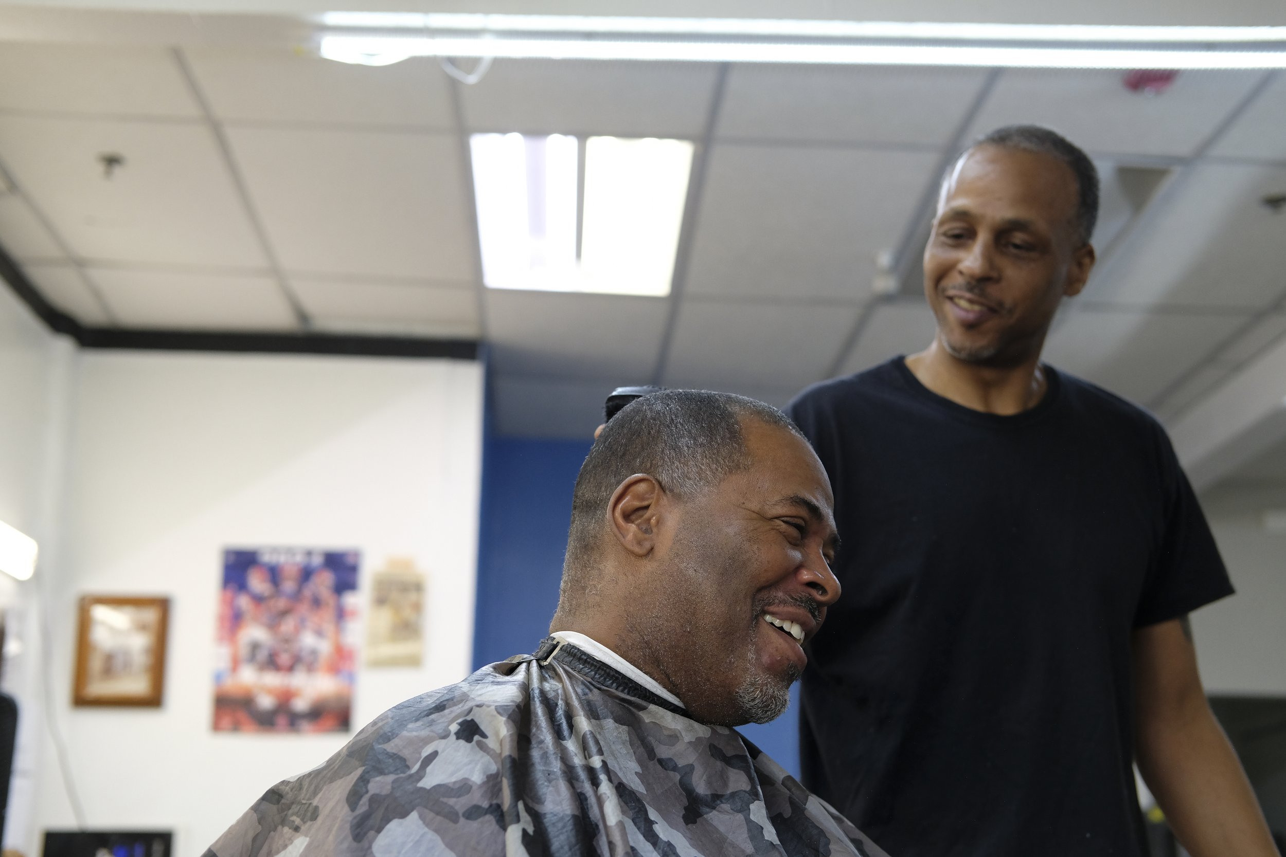  Barber Dexter Bullock smiles while shaving a patron's head at Blue Brothers Barber Shop on South Salina Street in Syracuse, May 23, 2026. Photo by Manila Southammavong. 