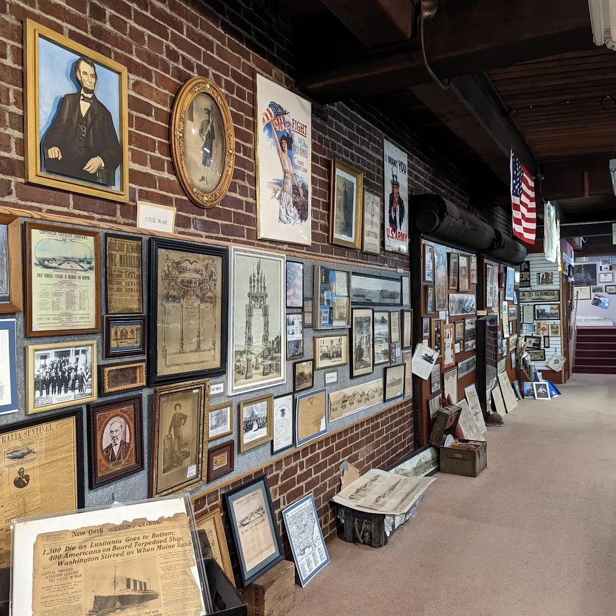 Wall with historical photos, portraits, and documents related to the Civil War and American history displayed in a museum or exhibit space.