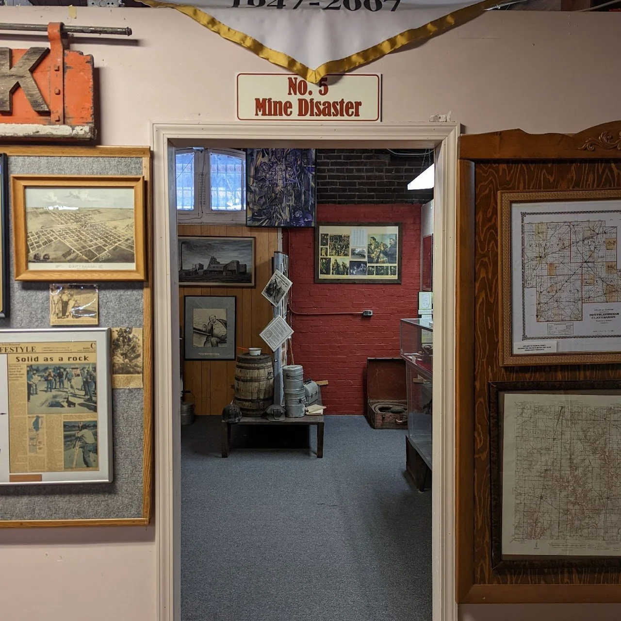 Entrance to an exhibit room titled 'No. 5 Mine Disaster,' with historical photographs, maps, and artifacts on display.