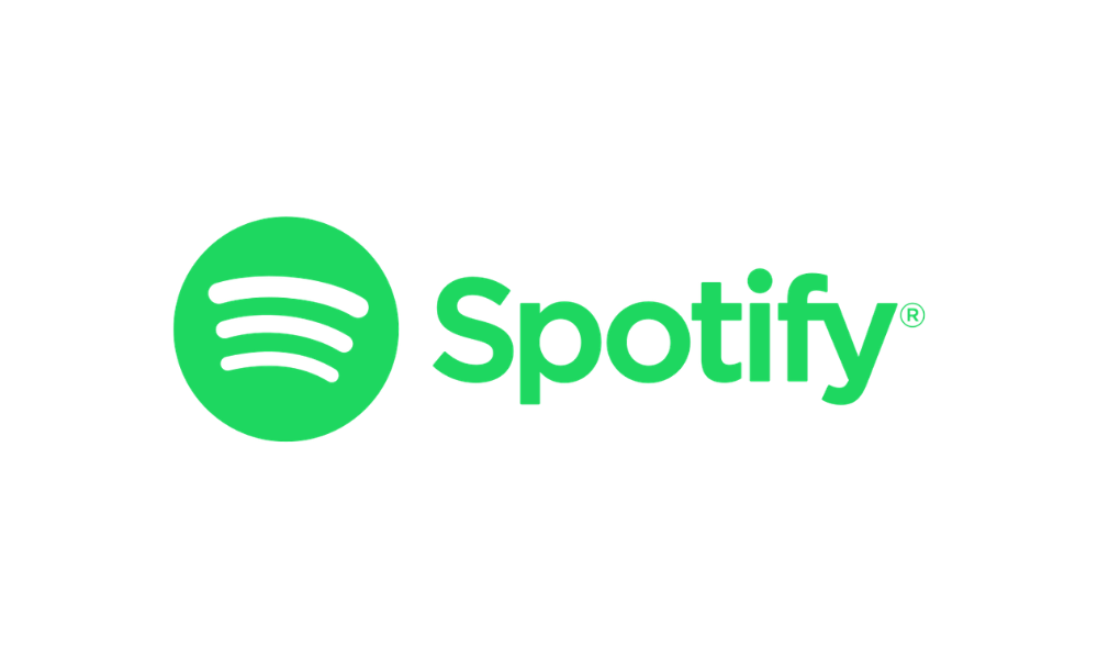 Green Spotify logo with the text 'Spotify' next to it on a black background.