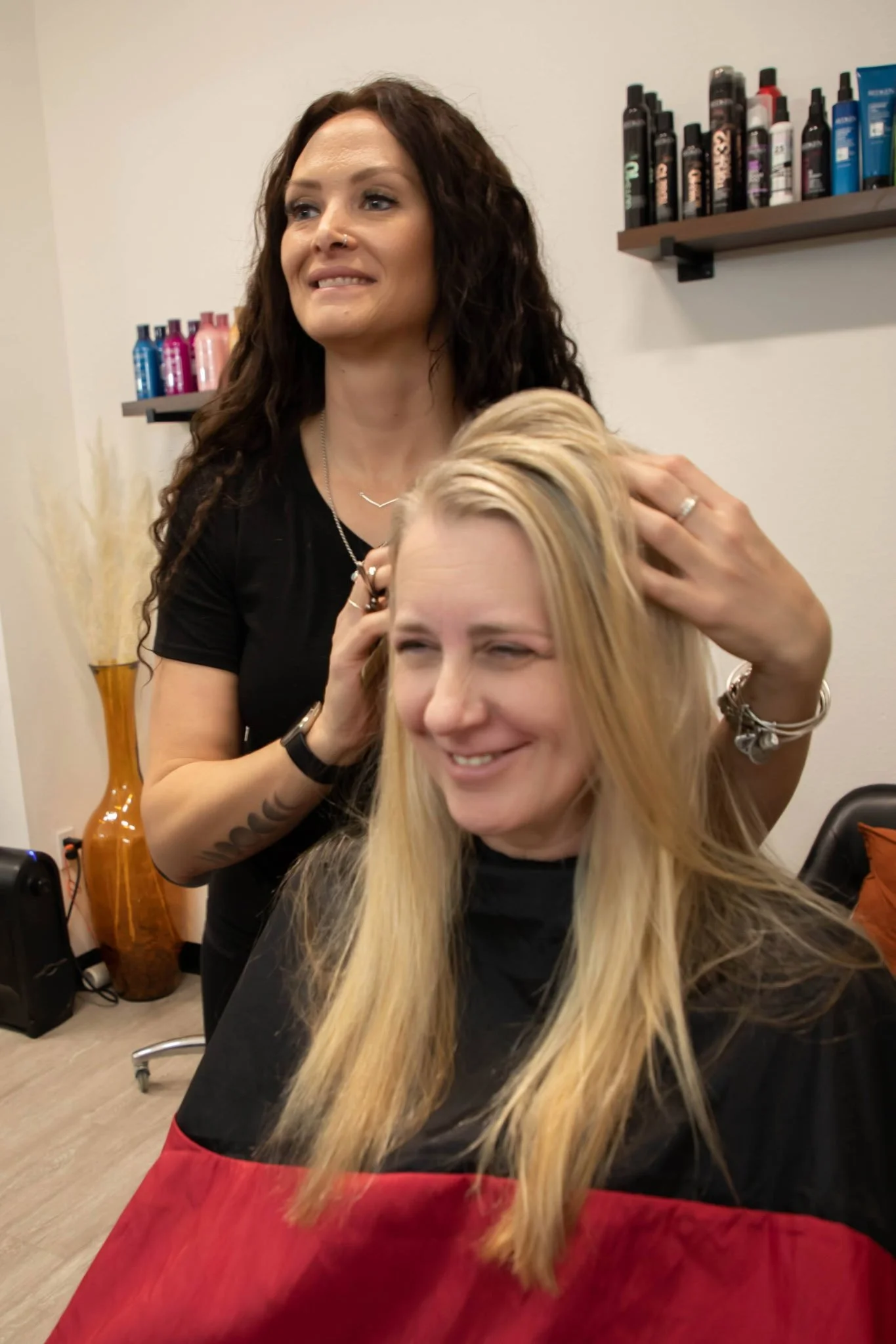 Stylist with hands in clients blonde hair