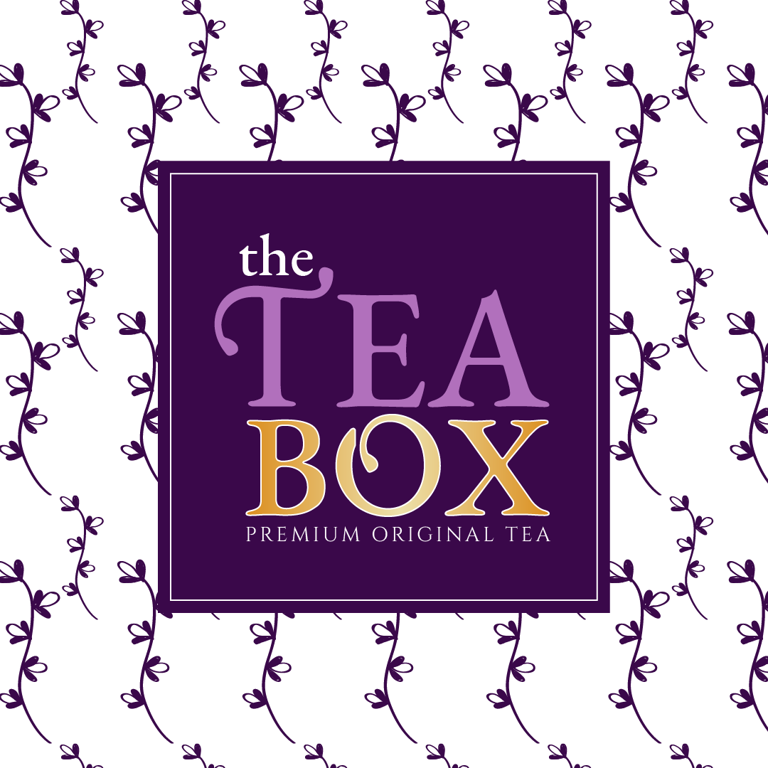 A tea box with a dark purple background, decorated with a pattern of purple tea leaves. The text on the box reads 'the TEA BOX' in large, stylized fonts, and below it says 'PREMIUM ORIGINAL TEA'.