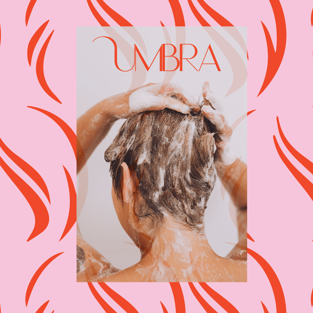 Person washing hair in a shower with soap lather, viewed from behind, with overlay text 'UMBRA' and a pink and red abstract background.