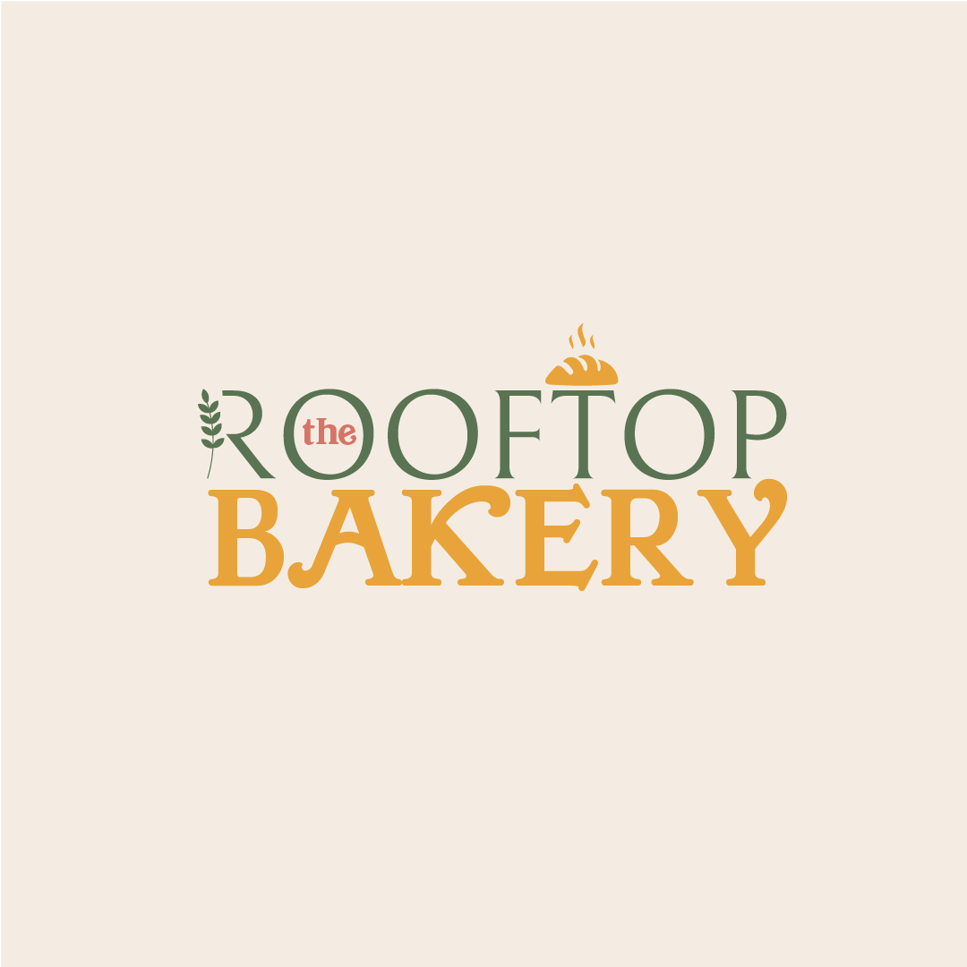 Logo for the Rooftop Bakery featuring stylized text with a bakery bread illustration and decorative elements