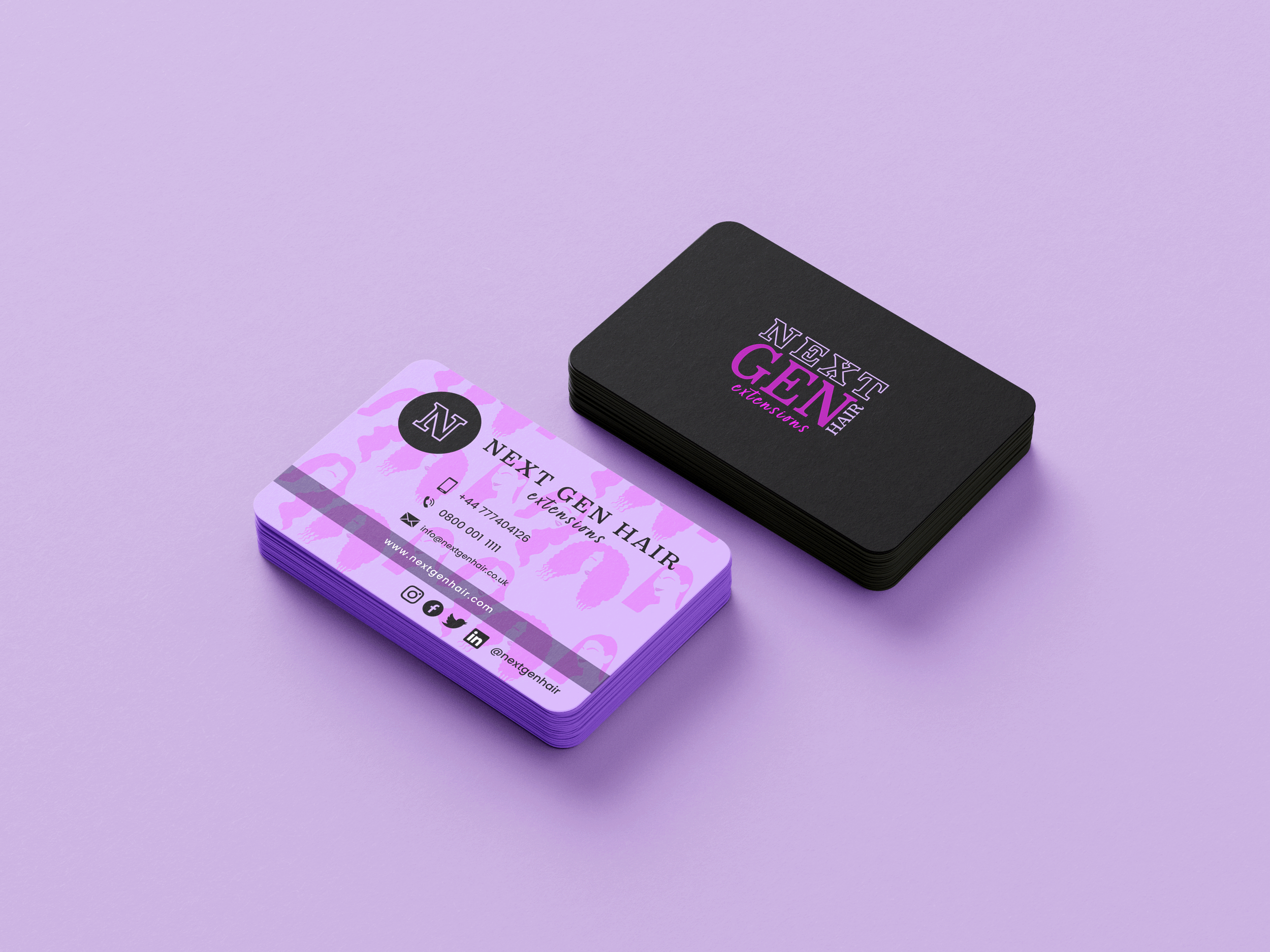 A stack of business cards for Next Gen Hair Extensions on a purple surface, with one card partially visible showing a pink and purple design and contact information.