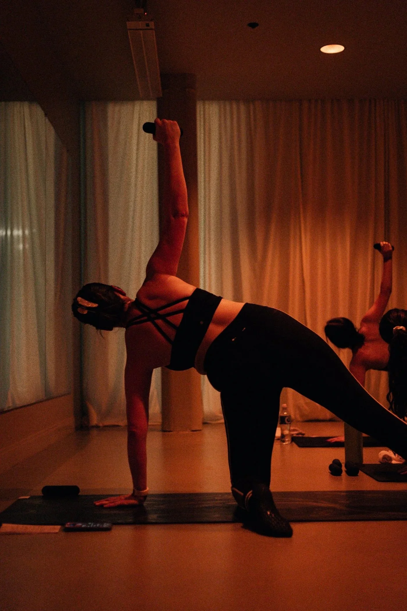 Woman in athletic wear mid-movement during Rhoë Pilates brand photography session — Nashville wellness photographer Alora Co Photo