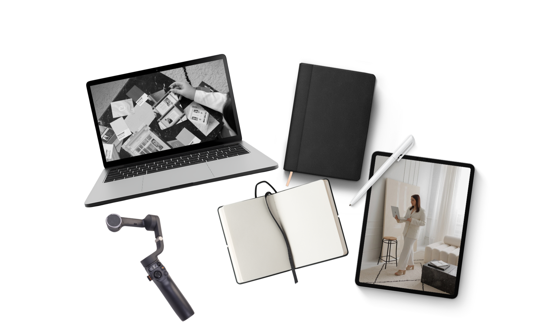 A collection of digital and traditional work tools including a laptop, tablet, smartphone gimbal, notebook, pen, and two tablet screens displaying people in a home setting.