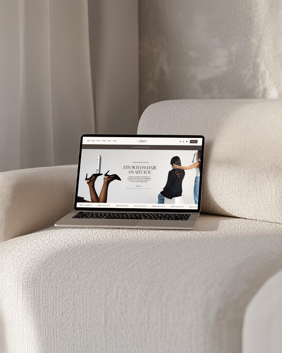 Open laptop displaying a hair salon website, with images of hairstyling and a person sitting in a salon chair.