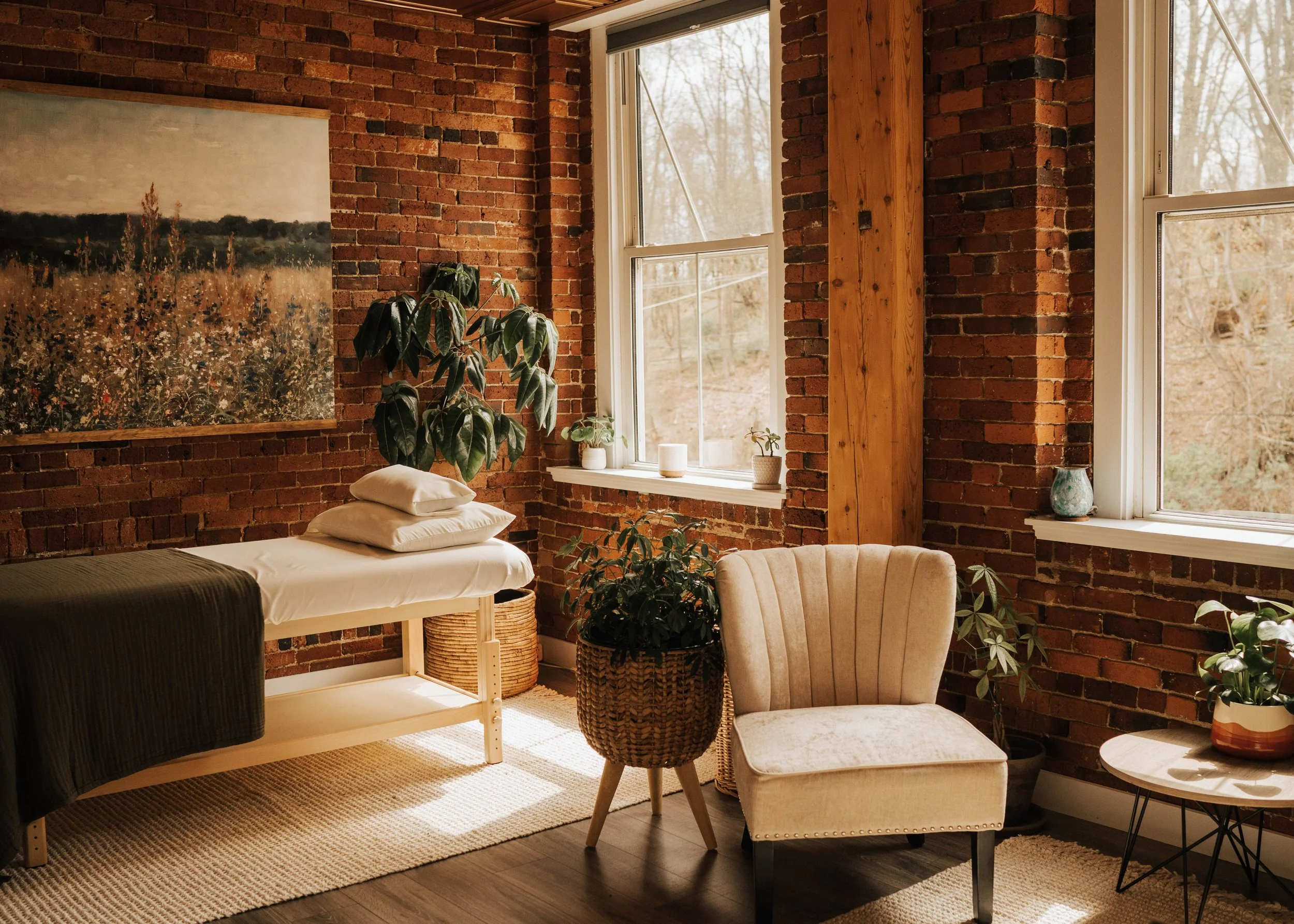 Healing room with large windows and a treatment table in Kristie LaRocca's office, where she provides energy healing, intuitive guidance, and Reiki.