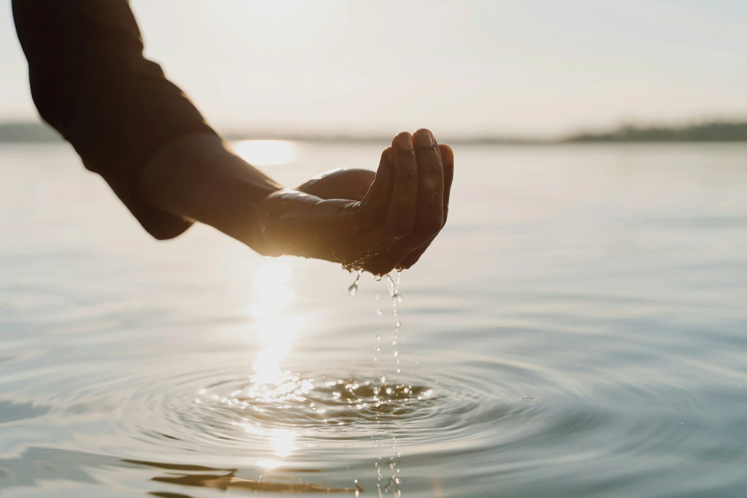Hand scooping water during an intuitive reading with Kirstie LaRocca