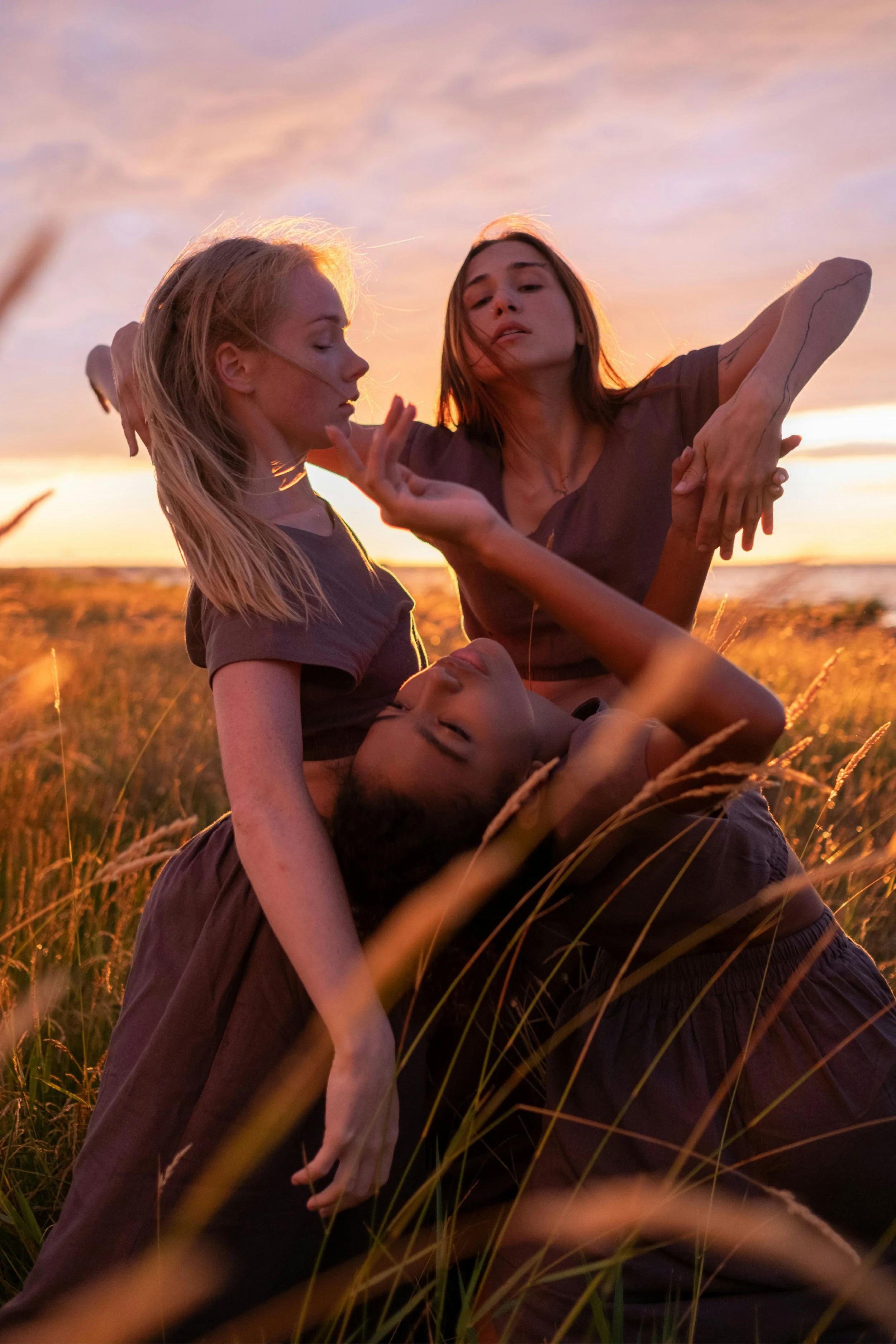 Three women dancing in a field during Kristie LaRocca's Workshop