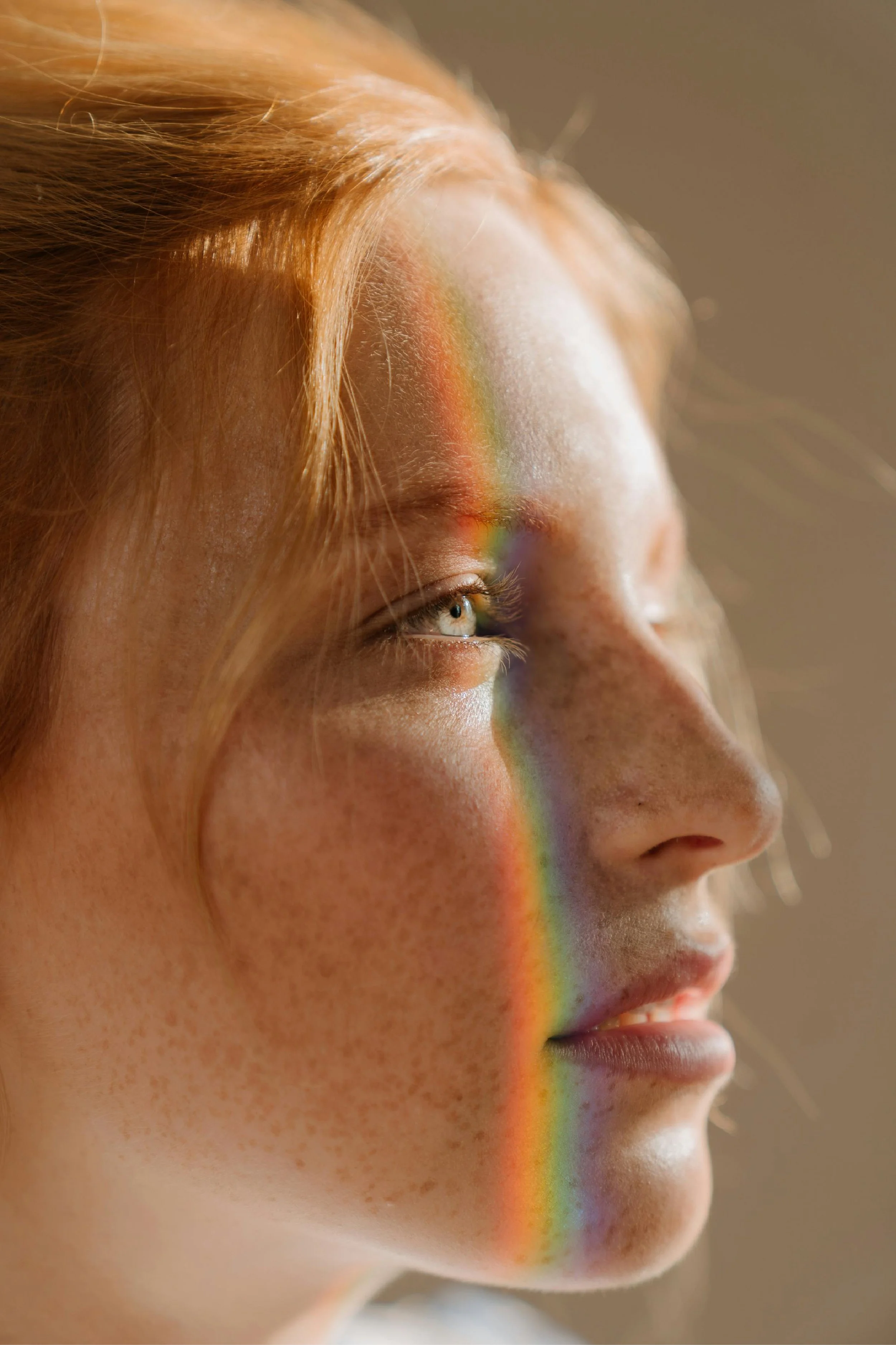 Woman with rainbow on her face