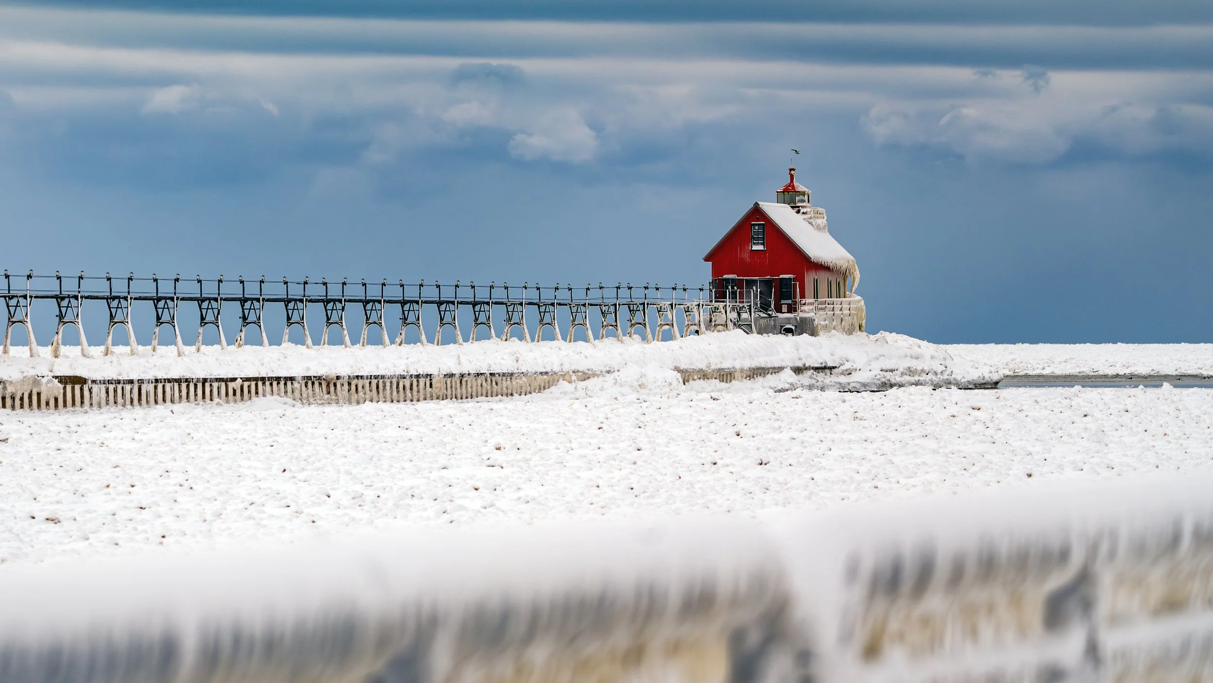 Grand Haven Lighthouse frozen and isolated in January 2026.