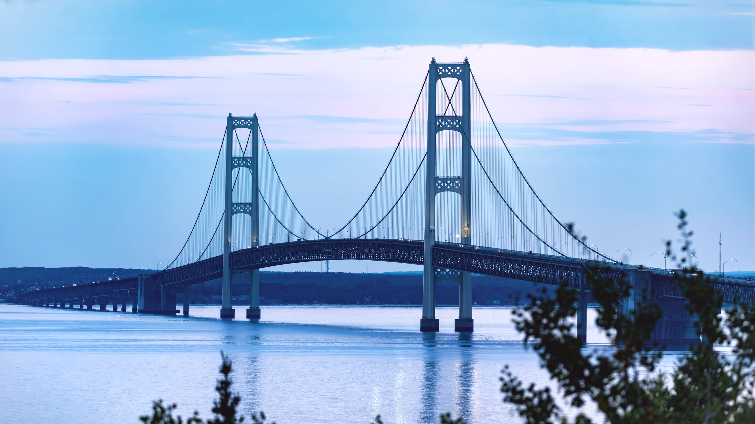 Mackinac Bridge reflecting across the Straits in September 2025.