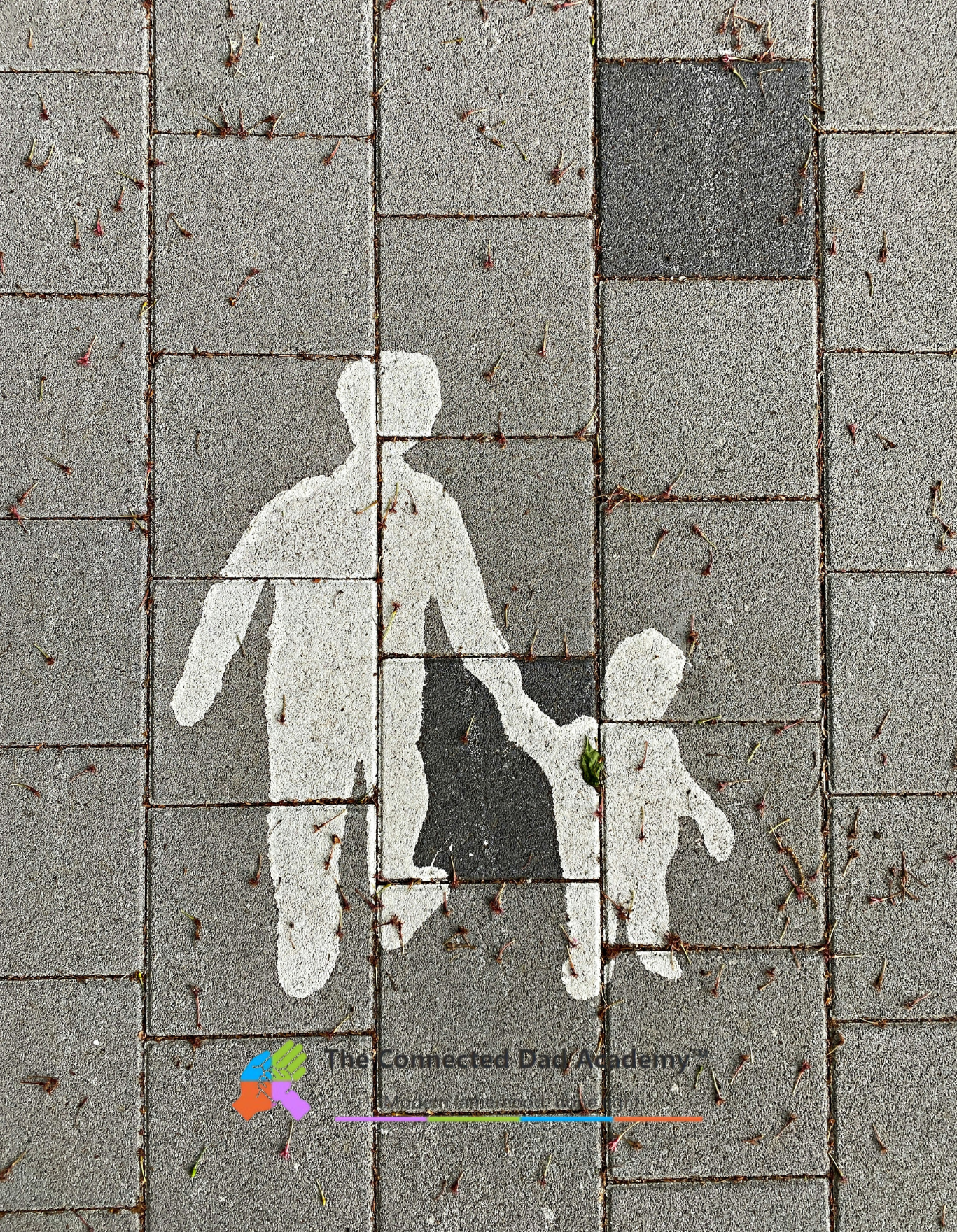 Street pavement with white silhouette of an adult holding a child's hand, with a logo and text at the bottom reading 'The Connected Dad Academy'.