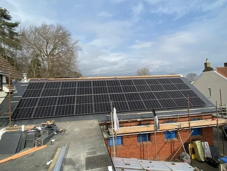 A comprehensive solar PV array integrated into a slate roof during construction