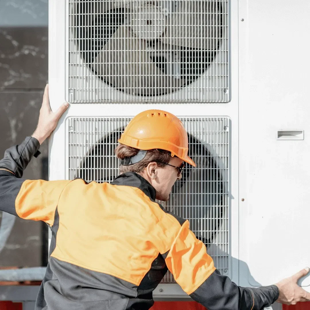 Helix Energy technician installing a high-efficiency air source heat pump