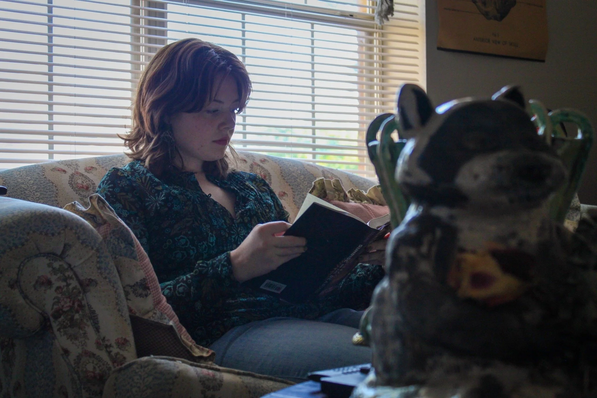 Catching Up on Some Reading - University of North Texas Senior Kat Hardy sits and reads her favorite book at her apartment in Denton on Saturday, May 2, 2026. Hardy wants to finish 10 books by the end of the summer.(photo by Genevieve Kaufmann)