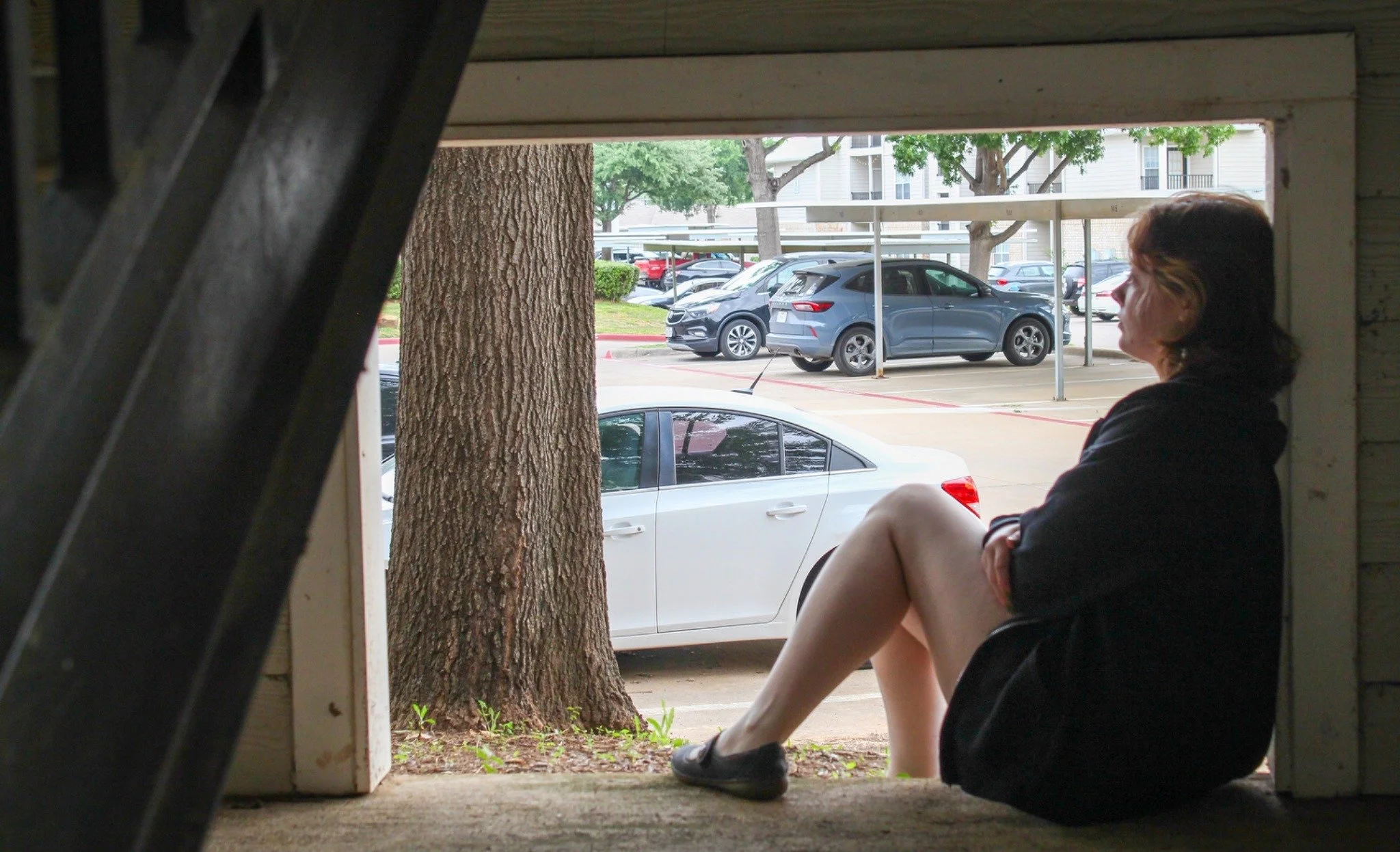 Taking Some Time - University of North Texas Senior Kat Hardy sits under her apartment stairs in Denton on Tuesday, May 5, 2026. One of Hardy's favorite spots to sit is under her stairs as it allows her time to think. (photo by Genevieve Kaufmann)