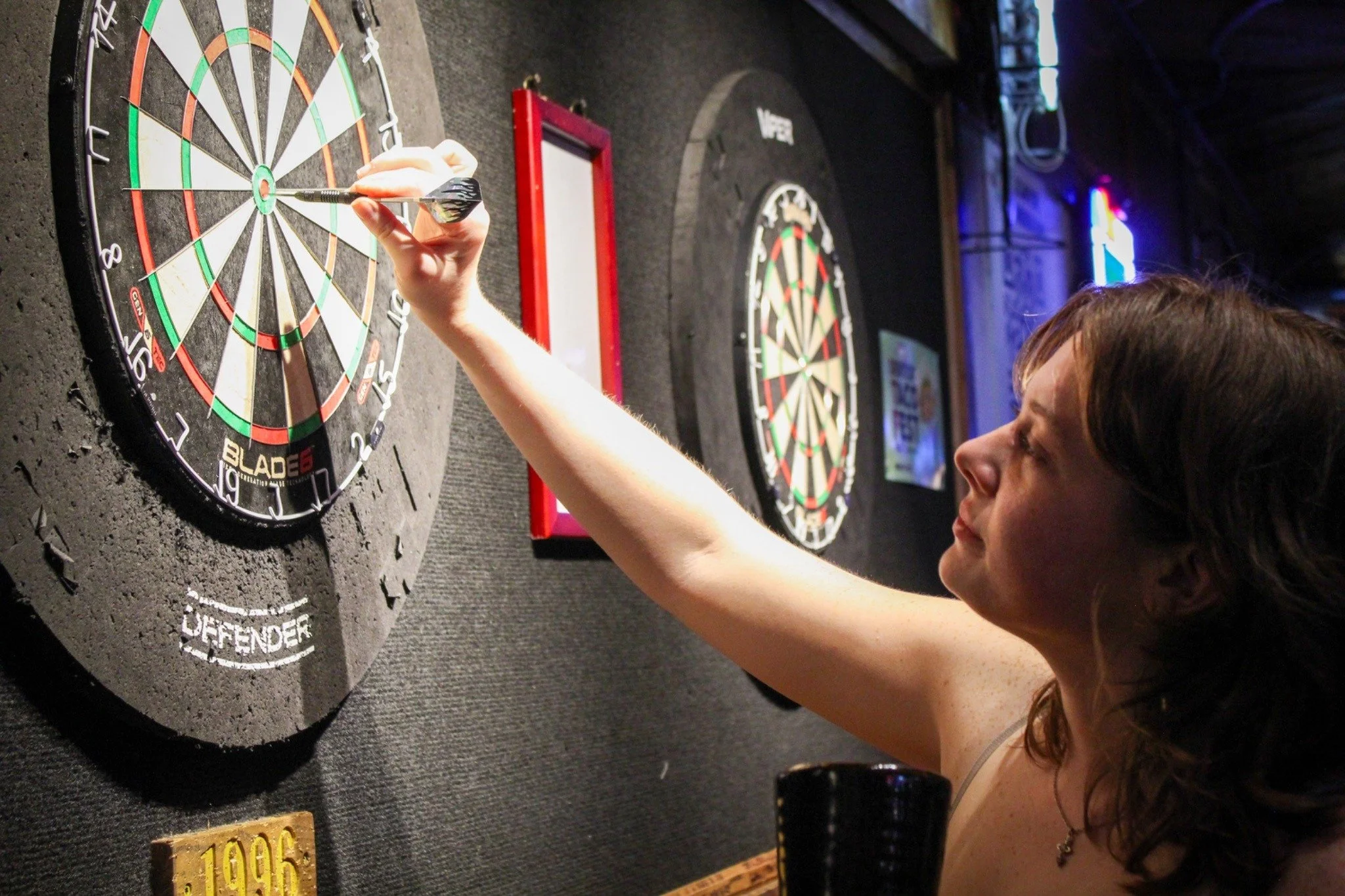 Bullseye for Pint Night - University of North Texas Senior Kat Hardy wins her dart game at Lucky Lou's in Denton on Tuesday, Apr. 28, 2026. (photo by Genevieve Kaufmann)