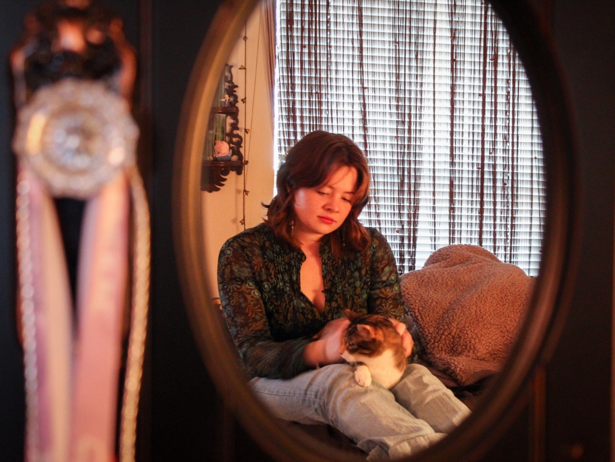 Moments of Calm - Ceramics major Kat Hardy sits on her bed with her cat Momo in her apartment in Denton on Saturday, May 2, 2026. (photo by Genevieve Kaufmann)