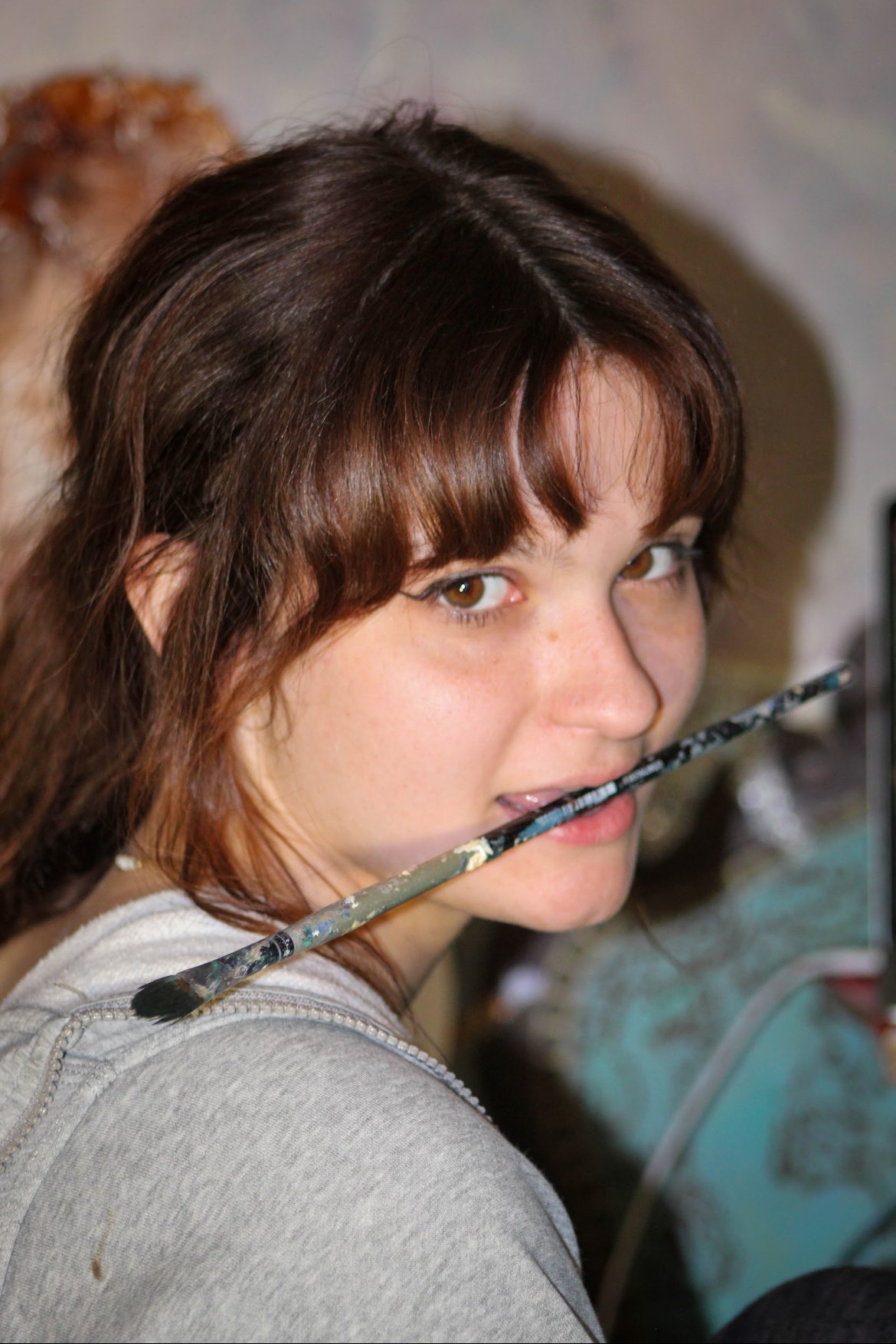University of North Texas Senior Syd Campbell poses with her paintbrush in her studio in Denton, Texas on Friday, April 3, 2026. Campbell is an Art Major and wants to create an art cooperation to inspire other artists in the area. (photo by Genevieve