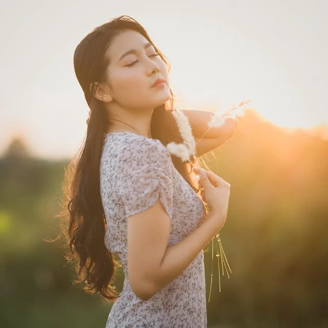 an asian woman breathing deeply