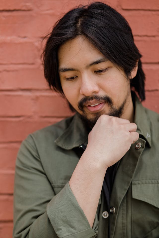 An asian man looking down