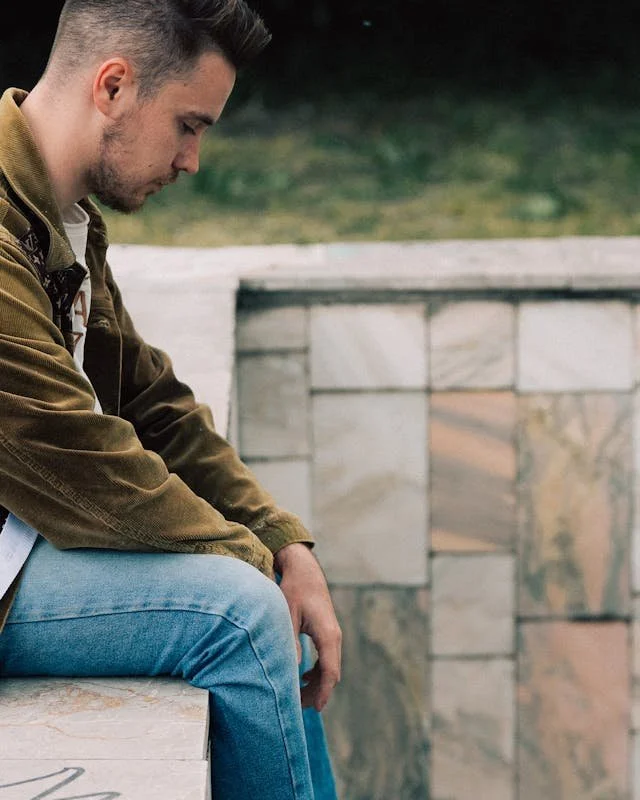 A man sitting looking sad