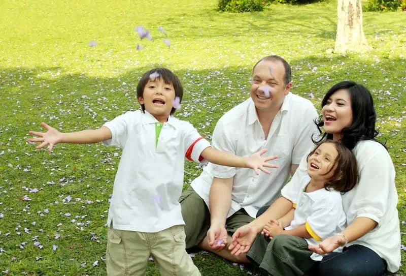 A happy family outside in a park