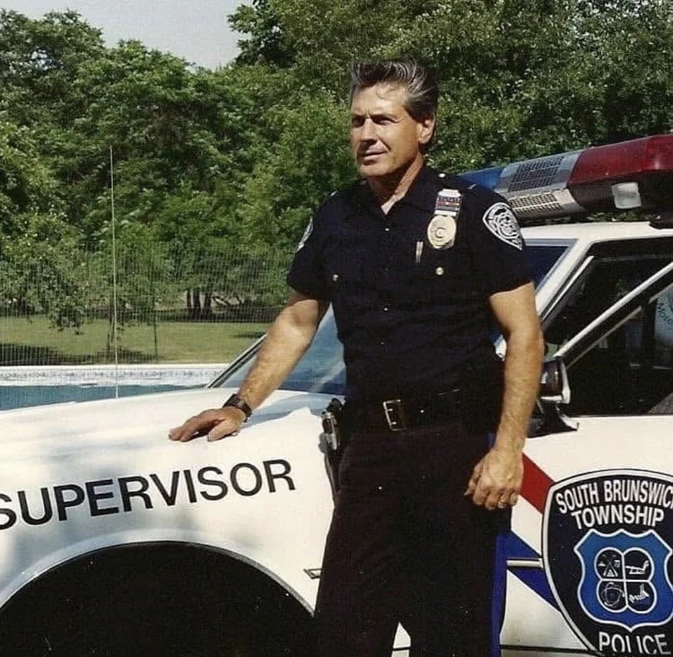 Anthony ‘Tony’ Santowasso in uniform beside a South Brunswick Police Department patrol car