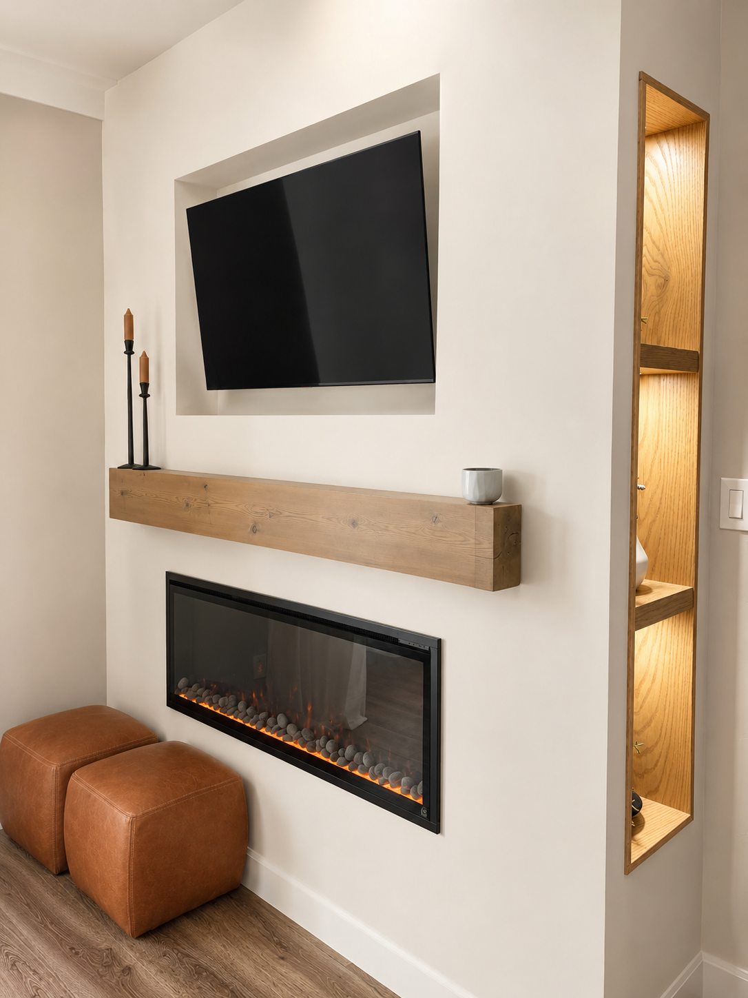 Modern bedroom corner with wall-mounted flat-screen TV, electric fireplace, wooden shelf, and decorative items.